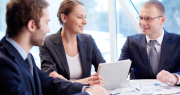 Group of confident business partners planning work at meeting